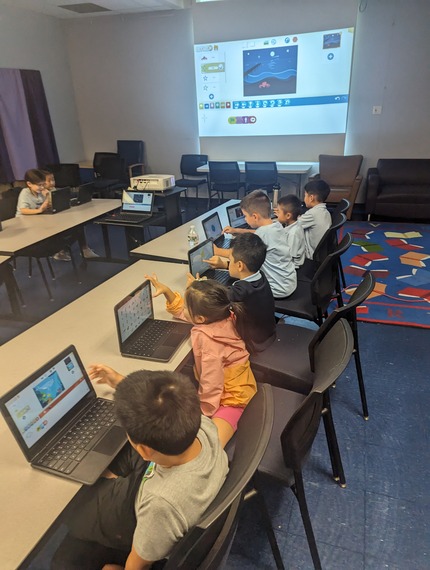 Students collaborating on coding projects at CodeMavericks